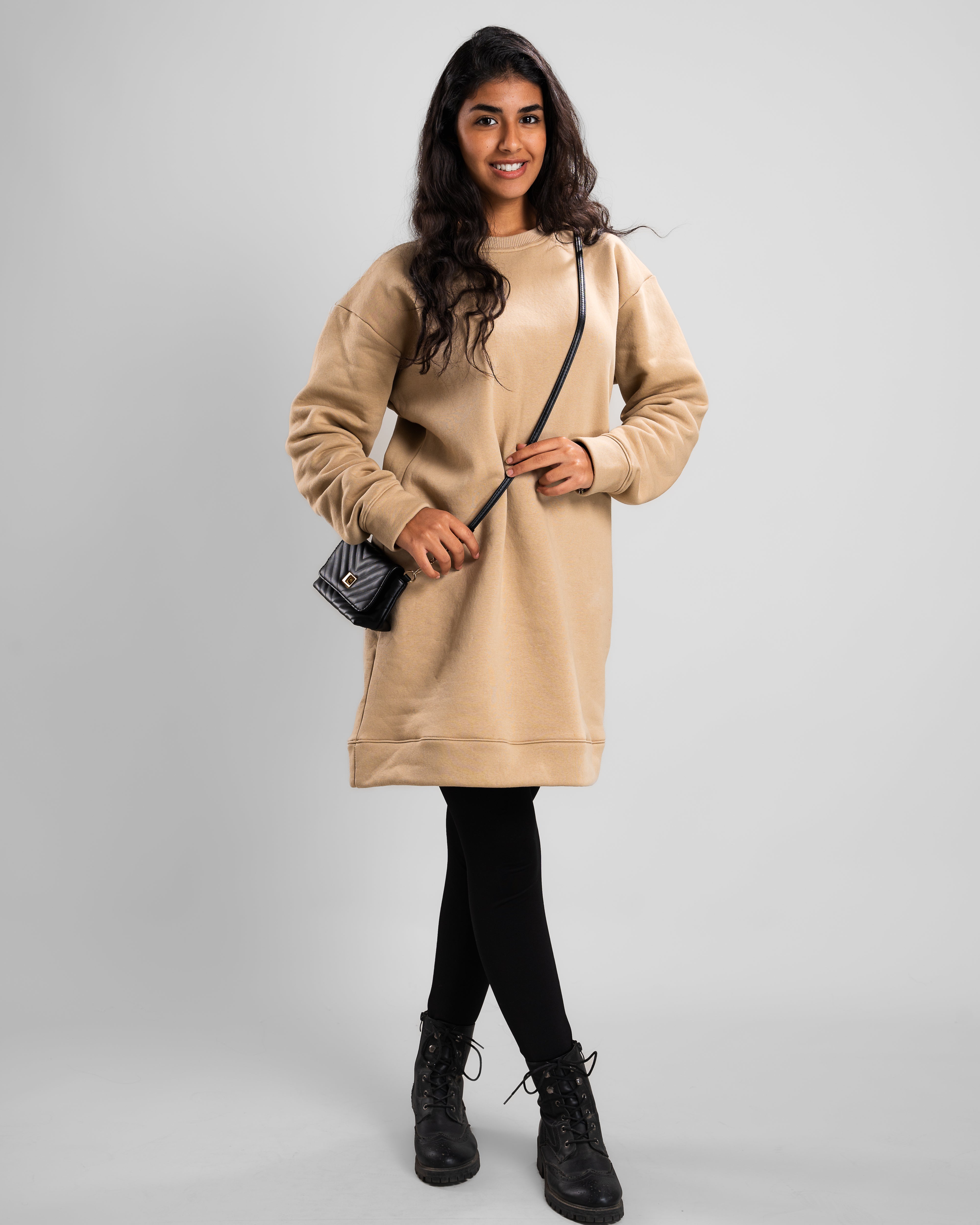 Cafe short dress styled with winter boots for a chic cold-weather outfit.